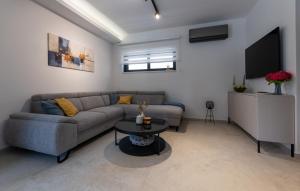 a living room with a couch and a table at Villa D Cube by Villas Guide in Kremena