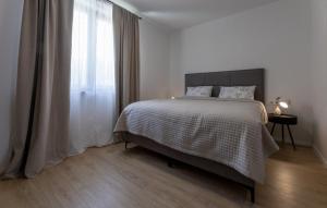a white bedroom with a bed and a window at Villa D Cube by Villas Guide in Kremena +16 photos
