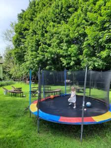 a little girl playing on a trampoline at Gościna U kowala in Lachowice
