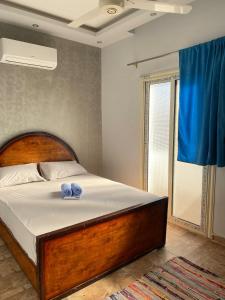 a bedroom with a bed with two blue towels on it at Dahabiya 2BR Sea View Residence Assala in Dahab