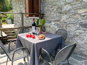 a table with a bottle of wine and a plate of food at Bel Pace in Sorico