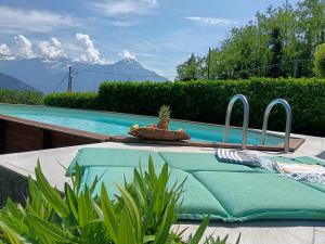 a swimming pool with a table with a table sidx sidx at Bel Pace in Sorico +36 photos