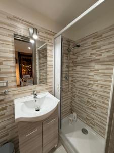 a bathroom with a sink and a shower at La Maison di Annamaria in Bari