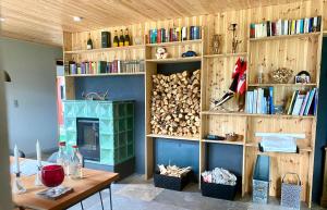 a living room with a fireplace and wooden shelves at s`gmiatli in Iselsberg