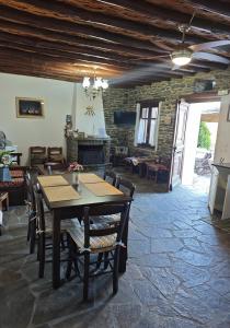a dining room with a wooden table and chairs at Anastasia Luxury Villas in Gavrio