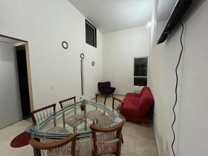 a dining room with a glass table and chairs at Casa Jardines del Mirador in San Juan del Río
