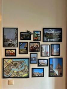 a group of pictures on a wall at Huisje 10D in Medemblik +1 photo