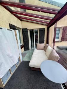 a living room with a couch and a table at Clos de la filature sauna et bien-être in Ronchamp
