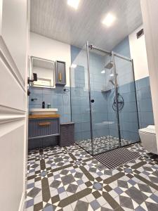 a bathroom with a shower and a sink at The Passenger Rooms Apartment in Tbilisi City