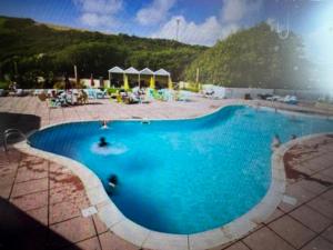a large blue swimming pool with a person in it at Newquay Bay Resort getaway in Porth