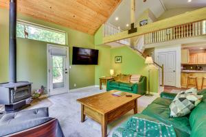 a living room with a green couch and a table at Ski, Kayak, Fish Ogden RioVista with Patio in Ogden