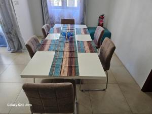 a conference room with a table and chairs at Mahina Sunset Heights in Flic-en-Flac
