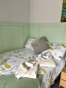 a bed with towels and pillows on it at The Old Ford inn in Llanhamlach +5 photos