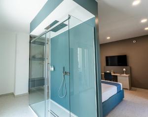a glass shower in a bedroom with a bed at Floral Apartment in Castellammare di Stabia +37 photos