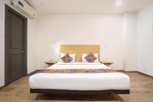 a bedroom with a large bed in a room at Via Royale 49 in Noida