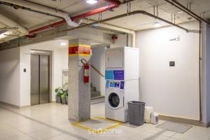 a washer and dryer in a room at Spot Jurere sophistication by the sea - SPJ's in Florianópolis