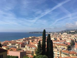 a view of a city with trees and the ocean at A SCANDINAVIAN EXCLUSIVE DESIGN RESIDENCE - PREMIUM LIVING - TWO PRIVATE BALCONIES w PANORAMIC SEA VIEW - 3 MIN TO BEACH - PARKING in Menton