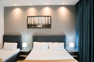 Postel nebo postele na pokoji v ubytování Atrium Deluxe Resort