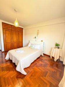 a bedroom with a bed and a wooden floor at Superhost Stay Garden View Double Room near Lisbon and Beaches in Corroios