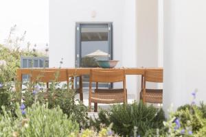 a patio with a table and chairs and a bowl on it at Ammilia Villa Naxos in Naxos Chora