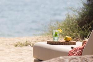 a drink on a table on the beach at Ammilia Villa Naxos in Naxos Chora