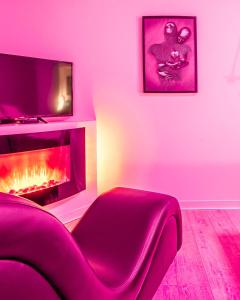a living room with a couch and a fire place at Le Lovely Narbonnais - Balneo & Sauna in Narbonne