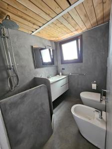 a bathroom with a toilet and a sink at Pantelleria Punta Tre Pietre 33 in Pantelleria