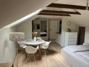 a room with a table and chairs and a bedroom at HellbergsApart in Bad Oeynhausen