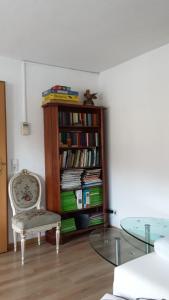 Una habitación con una estantería con libros y una mesa de cristal. en Renovierte Wohnung In Königstein, en Königstein