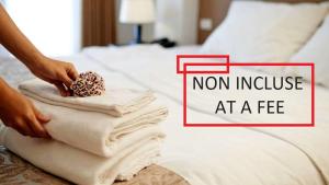a person putting towels on a bed with the words non invoice at a fee at Villaggio Mietta in Castiglioncello