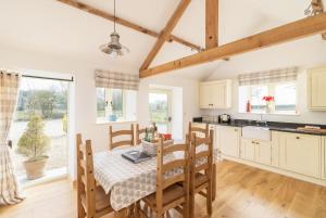 a kitchen and dining room with a table and chairs at Grange Cottage in York