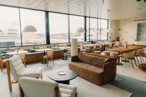 a large room with tables and chairs and windows at Design Apartment by The Farm - Azores Boutique House in Ponta Delgada