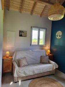 a living room with a couch and a window at L'Impasse du Jura in Ménétru-le-Vignoble