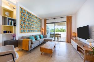 a living room with a couch and a tv at Golf Beach Vera in Vera
