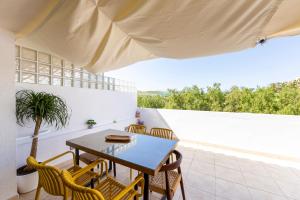 a dining room with a table and chairs on a patio at Golf Beach Vera in Vera