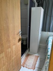 an open door to a bathroom with a toilet at Hotel Pousada Do Viajante in Erechim