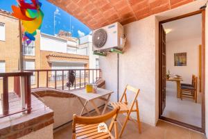 a balcony with a table and chairs and a heater at Mediterranean Way - Anguera in Cambrils