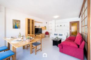 a living room with a red couch and a table at Mediterranean Way - Anguera in Cambrils +25 photos