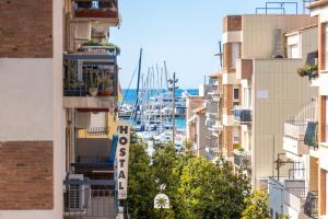 a view of a harbor from between buildings at Mediterranean Way - Anguera in Cambrils