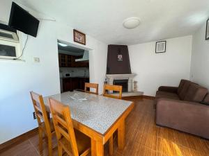 a living room with a table and a couch at Casa Outeiro Polo 1 in Marinhas