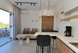 a kitchen and living room with a couch and a table at Morpheas Rooms in Palaiochora +61 photos