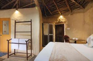 Voodi või voodid majutusasutuse Kithul cob hideaway toas