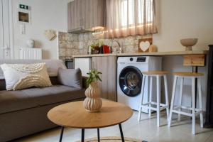 a living room with a couch and a table at Daniela Village House in Keri