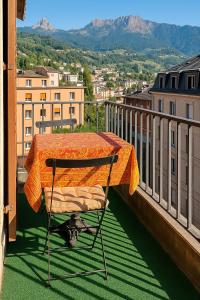 a chair sitting on a balcony with a table at Montreux Jazz festival apartment 5 PCS lake view in Clarens