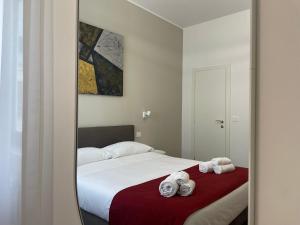 a bedroom with a bed with two towels on it at Maison Petruzzelli - Rooms in Bari in Bari