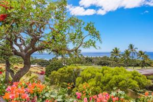 a view of a park with flowers and a tree at 4BD Villas (21) at Mauna Kea Resort in Waimea