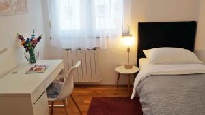 a bedroom with a bed and a table and a desk at Apartment in Cavle 54436 in Čavle
