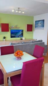 a living room with a table with a bowl of fruit on it at Apartment in Cavle 54436 in Čavle
