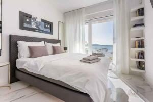 a bedroom with a large bed with a large window at Holiday home in Crikvenica 45063 in Crikvenica +31 photos