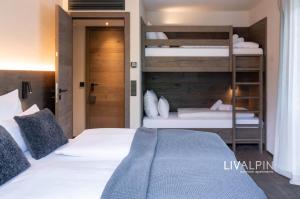 a bedroom with two beds and a bunk bed at LIVALPIN Relaxe in Garmisch-Partenkirchen